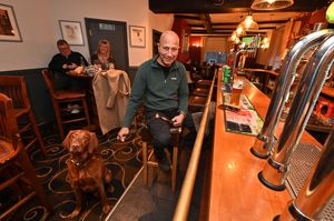 Clive Akinrinmade and Bentley get out of the rain to enjoy the pub