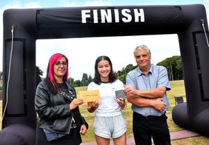 The winner in the 400m swim / 5k run female 15-18 age category - Emily Walker - with Maya Kluge and Builth Wells Deputy Mayor Councillor Alan Waller. Image by Ted Edwards Photography