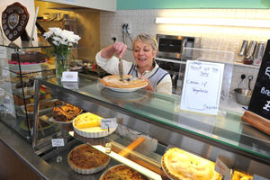 Joy Vance cutting a pie