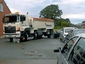 Supporting image for story: Lorry crushes front of car on garage forecourt
