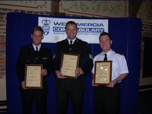 Billy Scott, centre, receiving a commendation