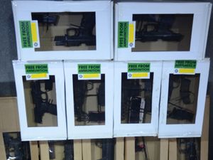 Several white boxes containing firearms