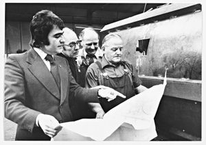 L. Nicklin, sheet metal firm, pictured in 1975. The image shows Barrie Henly going over a working drawing on the shop floor with (second left) Ted Waterfield, Ezra Thornton and Arthur Drew.