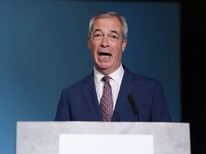 Nigel Farage speaking on stage