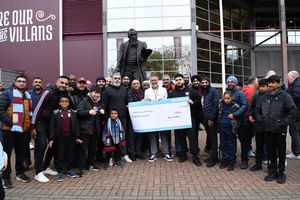 Punjabi Villans come together at Villa Park with fans and football pundit Guillem Balaque Taylor to present a £20,000 cheque to the Midland Langar Seva Society.