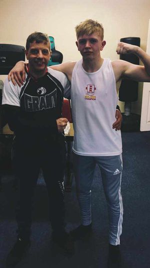 Wodensborough's Shaun Rutherford (right) tries on his West Midlands champion vest with his dad Martin.