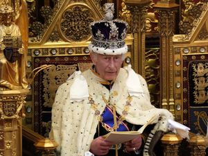 The King, wearing the Imperial State Crown, reads the King's Speech in the House of Lords Chamber during the State Opening of Parliament in the House of Lords in 2024
