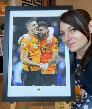 Claire Elliott with a print of her painting showing Conor Coady and Ruben Neves