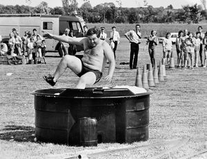 'Michael McLafferty of Donnington ambulance team makes quite a splash in the marathon team event at the Shropshire Fire Service It's a Knockout competition held at Telford Town Park on Saturday' reads the caption pasted on the back of this print in the Shropshire Star picture archive. It was taken on July 26, 1986.