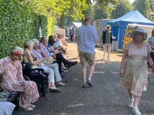 People seeking shade at the Flower Show.