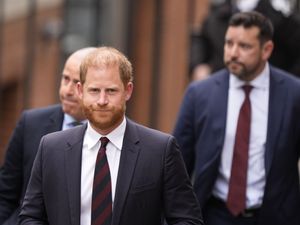 Duke of Sussex in suit and tie, walking outside court