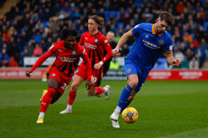 Tom Bloxham of Shrewsbury Town and Babajide Adeeko of Wigan Athletic (AMA)