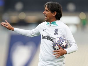 Simone Inzaghi holds a Champions League ball during an Inter Milan training session