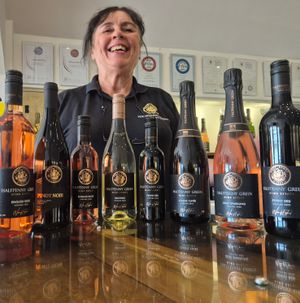 Helen Farquharson, vineyard tour guide, shows of Halfpenny Green Wine Estate's wines with the new-look labels