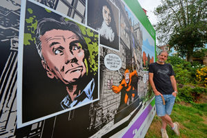 Walking Dead artist Charlie Adlard with the billboard he created as part of the Shrewsbury Comic Art Trail