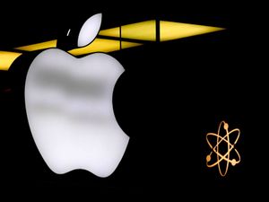 The Apple logo is illuminated at a store in Munich, Germany