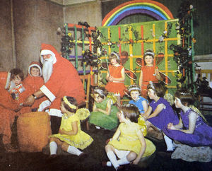 Father Christmas at Church Stretton, December 3, 1965. The caption reads: 'Santa made an early appearance on Saturday  at the annual Christmas fayre of the Church Stretton British Legion Women's Section. Surrounded by fairies in the Rainbow Room, he distributed toys from his large sack. The three children with him are Robbie and Stephen Horner and Suzanne Gough, all of Central Avenue.'