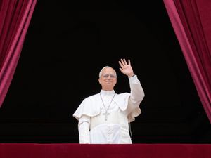 Pope Leo waves from a balcony
