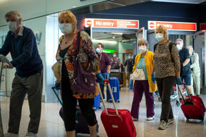 Passengers from the Holland America Line ship Zaandam walk through arrivals in Terminal 2 at Heathrow Airport in London, after flying back on a repatriation flight from Florida
