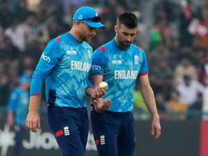 Jos Buttler, left, talks to Mark Wood