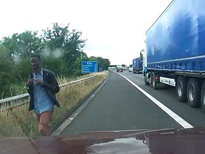 Supporting image for story: WATCH: Motorway driver helps police pick up migrants walking 100 miles to Midlands