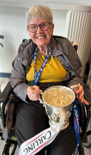Resident of Meadow Rose holding the 2011 League Cup