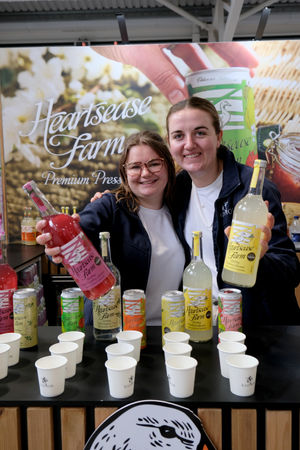 Libby Stokes and Megan Birch manning the Heartsease Farm stand, based at Radnor Hills, near Knighton. They were selling six flavours of the premium presse drink in cans and four flavours in bottles. The apple and rhubarb flavour recently won two stars at the Great Taste Awards. Image by Andy Compton