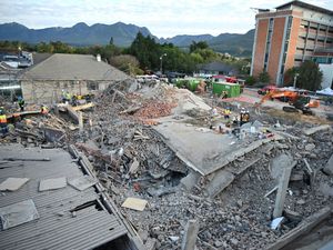 Supporting image for story: Rescuers bring survivors from the rubble after building collapse in South Africa