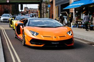 The brightly coloured supercars make their way towards the church