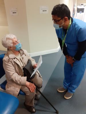 Dr Anand Rischie, Chair of Walsall Clinical Commissioning Group, talks to first patient Joan following her vaccination