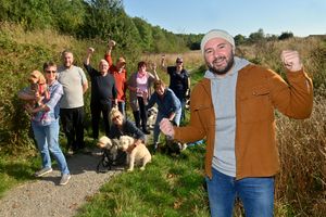 Campaigners are celebrating after plans to build on Damson Wood have been rejected. At the front is: Elliott Powell and with him are local residents: Marie Thompson, Clive Luty, David Bowden, Peter Lockley, Kath Thacker,Pam Lockley, Marie Thompson. Daryly Bowden and Lynda Lord and their dogs
