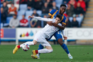 Chey Dunkley of Shrewsbury Town and Slobodan Tedic of Barnsley..