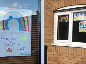 Supporting image for story: Children put rainbows in windows to raise spirits of passers-by