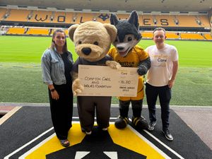 Wolfie and Custard, the respective charity's mascots, are pictured with Laura Cahill (Wolves Foundation) and Ian Groom (Compton Care).