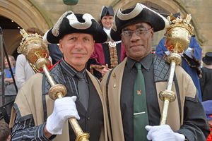 Richard Hunt and Dave Bourne wear ceremonial outfits and carry sceptres for the procession
