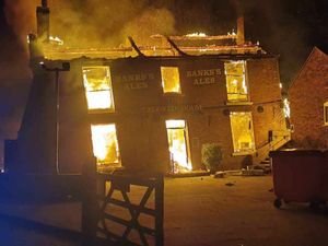 The Crooked House ablaze. Photo: Chris Green