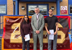 Principal Thomas Daly celebrates with students as they receive their A level results.