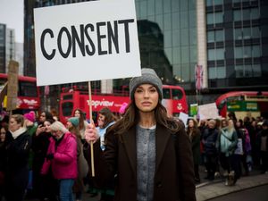 Vicky Pattison holds a sign saying 'Consent' during a protest