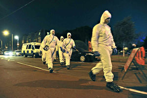 Investigation – police officers wearing forensic suits prepare to carry out a search near Wolverhampton Central Mosques last night