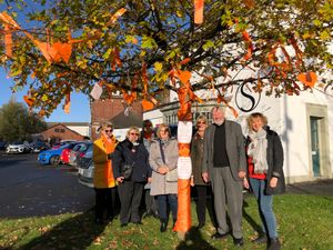 Members with their orange tree for the 16 Days of Activism Against Gender-based Violence campaign
