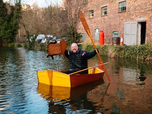 Supporting image for story: Antiques staff tackle flooding by rowing across car park in a boat