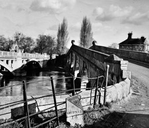 A February 1958 Atcham bridge picture. The old bridge is on the right, the 20th century bridge is on the left. The caption pasted on the back was about Shrewsbury market, so presumably the Atcham milestone was the connection or intended feature, even though we are looking away from Shrewsbury. (The caption read: 'Tuesday is a busy day in Shrewsbury. Farmers come from all over Shropshire to buy and sell cattle or for a day out and a friendly chat. The centre of Shrewsbury will soon lose this age old custom, for the market will shortly be transferred to Harlescott on the outskirts.' The date stamp on the print is February 18, 1958, which will be when taken, and the stamp by the caption is February 19, 1958, no doubt the publication date.