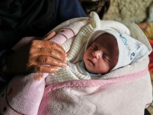 Ella Osama Abu Dagga, 25 days old, is held by her great-aunt Suad Abu Dagga