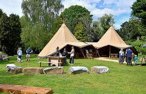 Vistors enjoy the sunny weather at Himley and find out about Glamping opportunities there.
