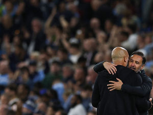 Vitor Pereira (R) hugs Manchester City's Spanish manager Pep Guardiola (Photo by DARREN STAPLES/AFP via Getty Images)          