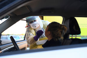 An nurse in protective clothing testing for the new virus