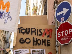 Signs at an anti-tourism protest in Spain