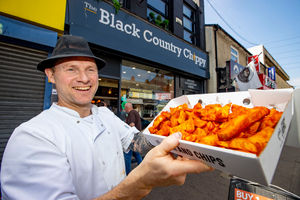 Dean Gilbert shows off the orange chips which make Black Country Chippy so popular