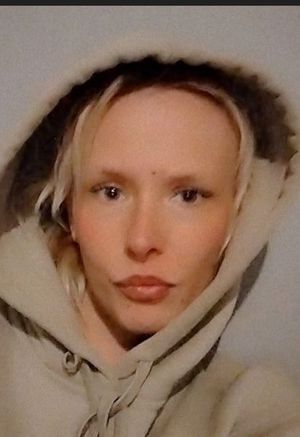 Demis is described as 5ft tall, with blond hair and is very slim. She is usually seen wearing rings on most of her fingers