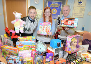 Rachel Lewis from Hope House Hospice pictured with Andy Jackson and Tim Drew from Storage King as she collects donations from this year's toy appeal